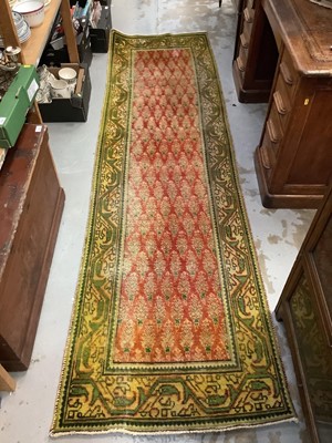 Lot 1092 - Eastern runner with geometric decoration on green and red ground, 290cm x 82cm