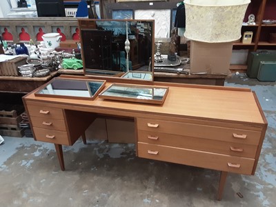 Lot 1094 - Mid 20th century teak dressing  table with raised triple mirror back and drawers below