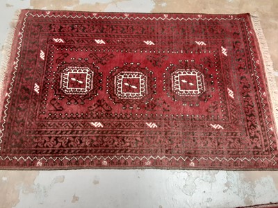 Lot 1095 - Eastern rug with geometric decoration on red and black ground, 122cm x 78cm