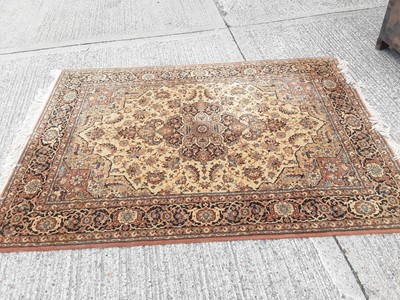 Lot 1102 - Eastern rug with geometric decoration on beige ground, 240cm x 170cm