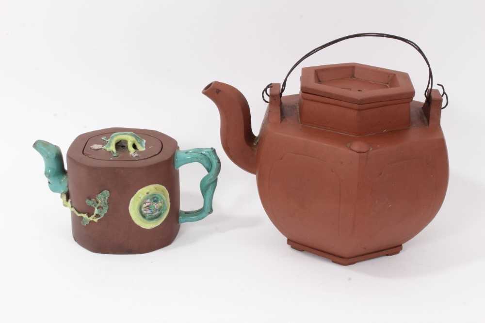 Lot 3 - Two Chinese Yixing teapots, 19th/20th century, the first of hexagonal form, seal marks to cover and base, 16cm high, the other with branch form handle and spout, enamelled in relief, 10cm high