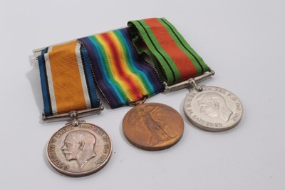 Lot 713 - First / Second World War medal trio comprising War and Victory medals named to G - 63538 PTE. N. W. Emmerson. The Queen's R, and Second World War Defence medal (mounted on bar)