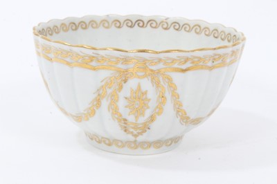 Lot 20 - Worcester fluted tea bowl and saucer, circa 1775-80, decorated in gilt with swags and other patterns, the saucer measuring 14cm diameter