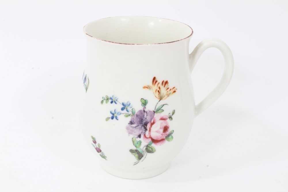 Lot 32 - Derby baluster shaped mug, circa 1760, polychrome painted with floral sprays, red painted rim, 10cm high