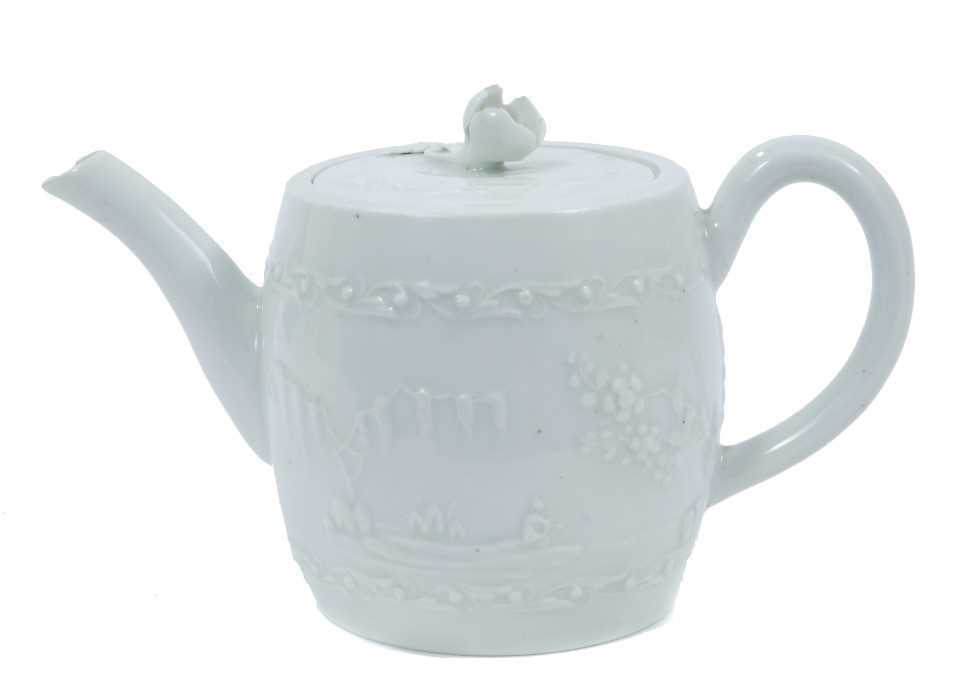 Lot 48 - Worcester white-glazed teapot, circa 1760, of barrel form, decorated in relief with a Chinese fishing scene on one side, and flowers verso, 18cm from spout to handle