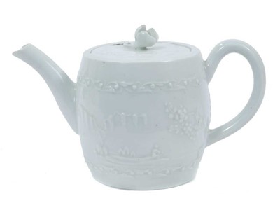 Lot 222 - Worcester white-glazed teapot, circa 1760, of barrel form, decorated in relief with a Chinese fishing scene on one side, and flowers verso, 18cm from spout to handle