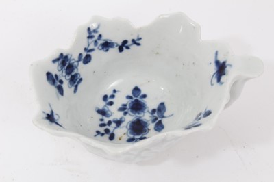 Lot 54 - Worcester blue and white leaf moulded butter boat, circa 1755, decorated with floral sprays, painter's mark to bottom of handle, 8.5cm long