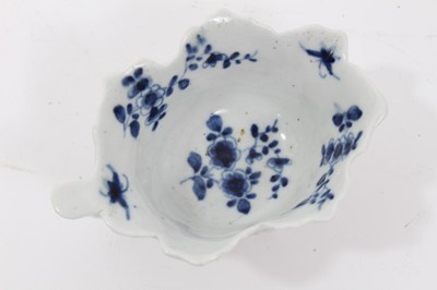 Lot 54 - Worcester blue and white leaf moulded butter boat, circa 1755, decorated with floral sprays, painter's mark to bottom of handle, 8.5cm long