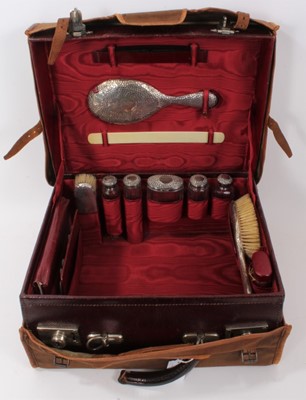 Lot 873 - Early 20th century vanity case with silver fittings