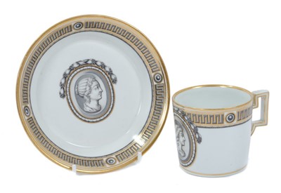 Lot 69 - Vienna coffee can and saucer, circa 1780, painted en grisaille with a portrait in profile, the edge with fret pattern, highlighted in gilt, underglaze blue marks to bases, the saucer measuring 13.5...