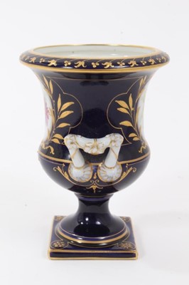 Lot 71 - Small Berlin porcelain campana vase, circa 1880, painted with flowers on a gilt and cobalt blue ground, marks to base, 9.75cm high