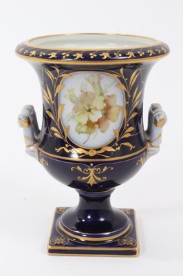 Lot 59 - Small Berlin porcelain campana vase, circa 1880, painted with flowers on a gilt and cobalt blue ground, marks to base, 9.75cm high