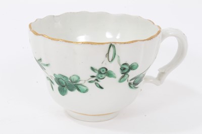 Lot 74 - Bristol cup and saucer, circa 1772-75, decorated in green enamels with swags of flowers, with gilt rims, B marks to bases, the saucer measuring 12cm diameter