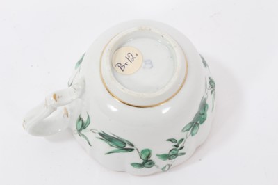 Lot 74 - Bristol cup and saucer, circa 1772-75, decorated in green enamels with swags of flowers, with gilt rims, B marks to bases, the saucer measuring 12cm diameter