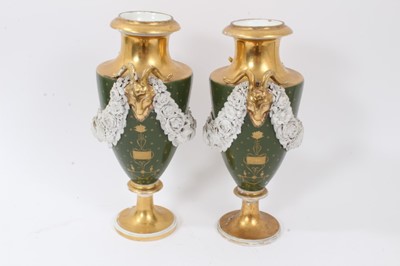 Lot 79 - Pair of Paris porcelain vases, 19th century, decorated with swags of encrusted flowers on a green and gilt ground, 29cm high