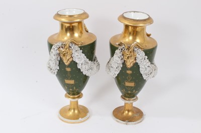 Lot 76 - Pair of Paris porcelain vases, 19th century, decorated with swags of encrusted flowers on a green and gilt ground, 29cm high