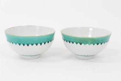 Lot 77 - Pair of unusual Bow tea bowls, circa 1770, with pineapple moulding, turquoise borders, and flower at the bottom, marks to base, 7.75cm diameter
