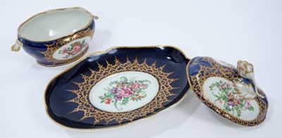 Lot 86 - Worcester oval sauce tureen, cover and stand, circa 1772-75, polychrome painted with flowers on a cobalt blue and gilt ground, the stand measuring 23cm across