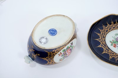 Lot 86 - Worcester oval sauce tureen, cover and stand, circa 1772-75, polychrome painted with flowers on a cobalt blue and gilt ground, the stand measuring 23cm across