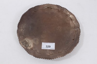 Lot 329 - George III silver salver of circular form with gadrooned border on three hoof feet (London 1767)