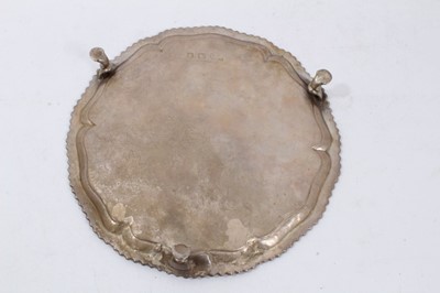 Lot 329 - George III silver salver of circular form with gadrooned border on three hoof feet (London 1767)