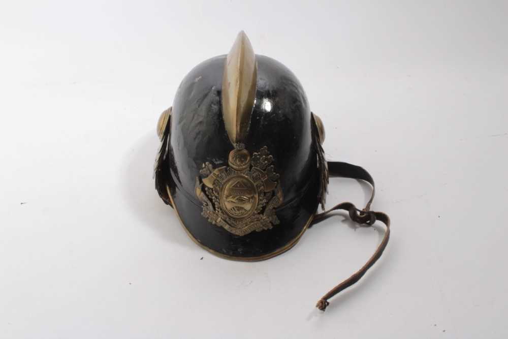 Lot 741 - 1920's German steel Fireman's helmet in black painted finish with brass comb, badge and chin strap, with leather head band.