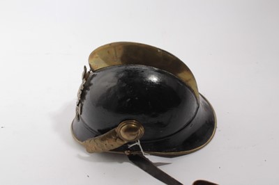 Lot 741 - 1920's German steel Fireman's helmet in black painted finish with brass comb, badge and chin strap, with leather head band.