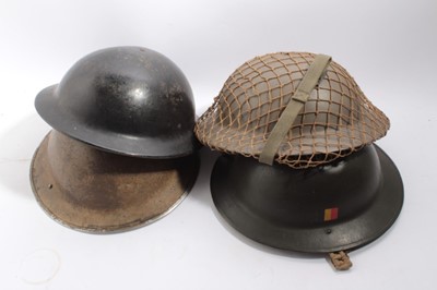 Lot 743 - Second World War British Military MKII Steel Helmet with camouflage painted finish, with chinstrap and liner, together with a Second World War Home Front Bakelite Helmet made by Plasfort and two ot...