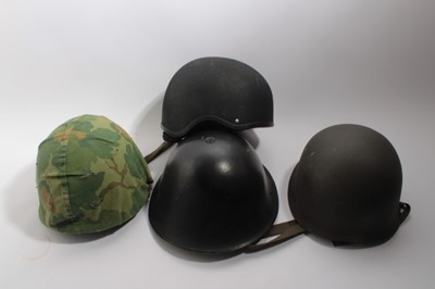 Lot 744 - American M1 pattern steel helmet with camouflage covering together with a Second World War British Zuckerman steel helmet and 5 other helmets (7)