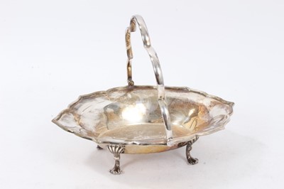 Lot 353 - Edwardian silver swing handled dish of shaped oval form, with raised border and scallop handle