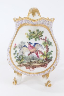 Lot 248 - Sèvres milk jug, circa 1770, probably painted by Evans, with scalloped rim and standing on three feet, the front decorated with a tropical bird, on a patterned ground, marks to base, 11.5cm high