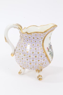 Lot 89 - Sèvres milk jug, circa 1770, probably painted by Evans, with scalloped rim and standing on three feet, the front decorated with a tropical bird, on a patterned ground, marks to base, 11.5cm high
