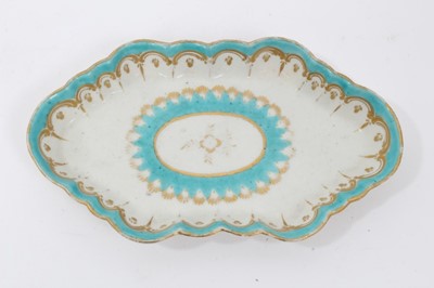 Lot 95 - Two 18th century Worcester items, including a spoon tray, of lozenge form, decorated in light blue and gilt, and a faceted tea bowl, polychrome painted with flowers