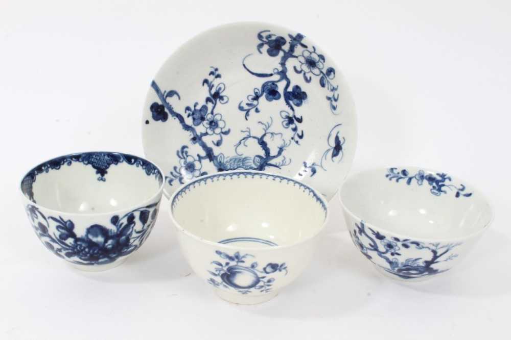 Lot 97 - Worcester tea bowl and saucer, circa 1758, painted in blue with the Prunus Root pattern, together with two other Worcester blue and white tea bowls (4)