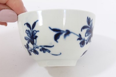 Lot 97 - Worcester tea bowl and saucer, circa 1758, painted in blue with the Prunus Root pattern, together with two other Worcester blue and white tea bowls (4)