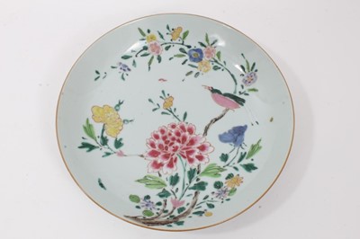 Lot 98 - Chinese famille rose saucer dish, Qianlong period, decorated with an exotic bird perfected on a branch, surrounded by various flowers, 21.75cm diameter