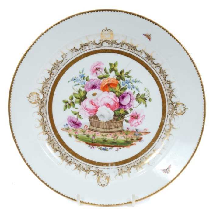 Lot 101 - Swansea plate from the Burdett Coutts service, circa 1815-17, finely painted with an overflowing basket of flowers, with gilt patterned border, marks to base, 22.5cm diameter