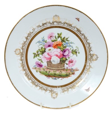 Lot 278 - Swansea plate from the Burdett Coutts service, circa 1815-17, finely painted with an overflowing basket of flowers, with gilt patterned border, marks to base, 22.5cm diameter