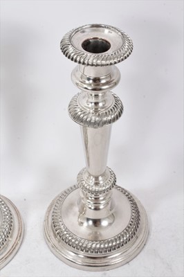 Lot 370 - Pair of Old Sheffield plate candlesticks with stepped sloped gadroon borders