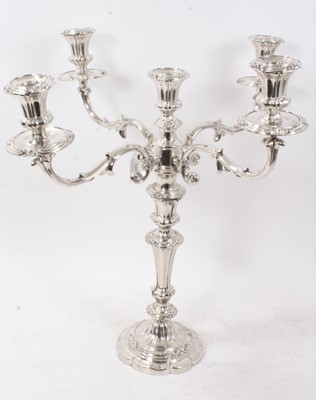 Lot 373 - Old Sheffield plate candelabrum on a scalloped base with scroll and floral borders