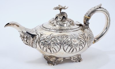 Lot 380 - George IV silver teapot of compressed melon form, with panels of foliate decoration