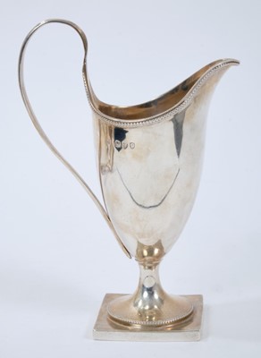 Lot 385 - Victorian silver helmut cream jug, with reeded loop handle, on a square base