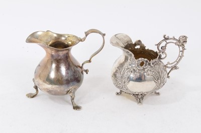 Lot 388 - Victorian silver cream jug of baluster form, with scroll handle, on three paw feet