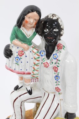 Lot 167 - Staffordshire pottery group of Uncle Tom and Little Eva