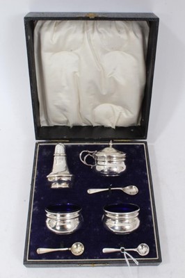 Lot 392 - 1920s silver four piece condiment set, comprising pair salts, mustard and pepper in a fitted case