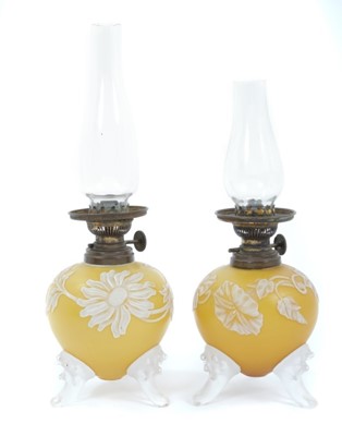 Lot 840 - Rare pair of Victorian miniature oil lamps with overlaid glass in the manner of Thomas Webb & Sons