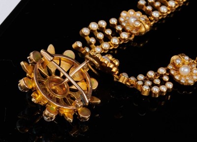 Lot 469 - Victorian gold seed pearl and diamond pendant necklace with detachable pendant/brooch, the star shape flower with a central old cut diamond, suspended from a gold and seed pearl fringe necklace wit...