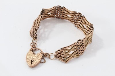 Lot 559 - Edwardian 9ct rose gold gate bracelet with engraved padlock clasp, approximately 21cm length.