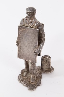 Lot 738 - Modern silver menu holder modelled as a man with a sandwich board, the menu holder formed as a '5 mile' milepost , height 5.5cm, by Thomas Charles Jarvis, London, Thomas Charles Jarvis