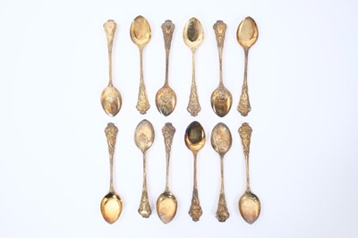 Lot 407 - Set of twelve silver gilt ice cream spoons, with ornate cast stems